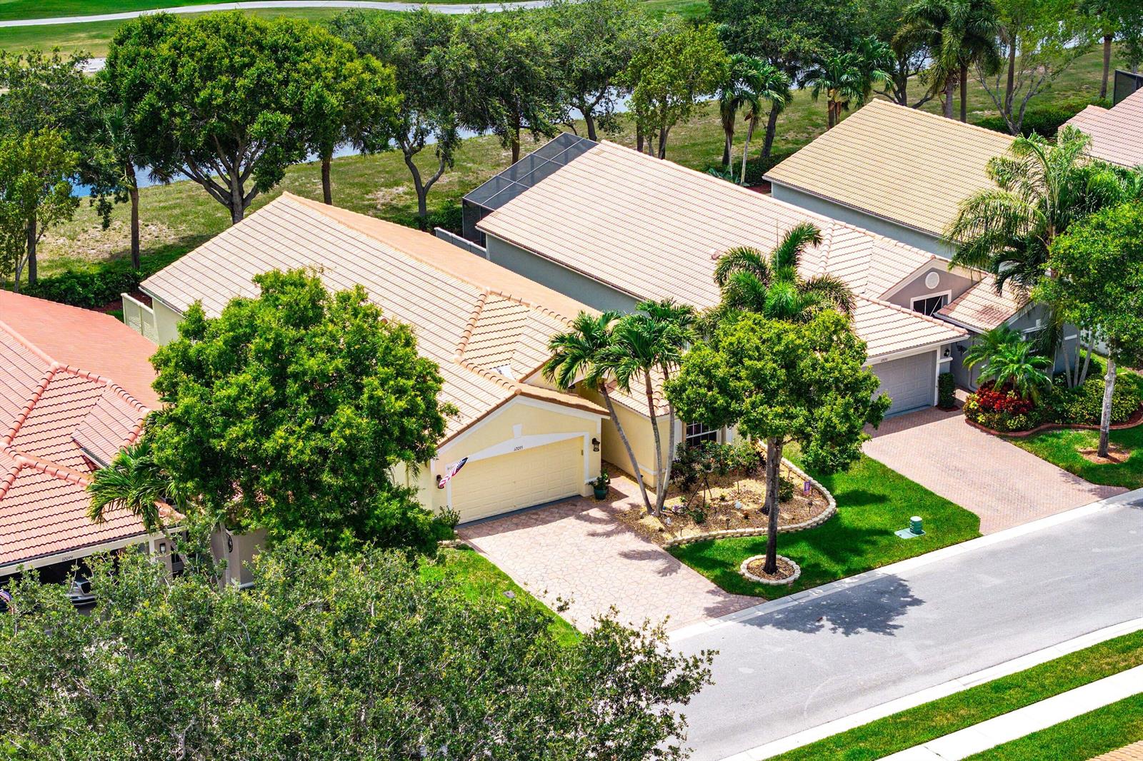 An aerial view shows two suburban houses with tan tile roofs and paved driveways — 12095 Roma Road, Boynton Beach FL 33437, BOYNTON BEACH, FL
