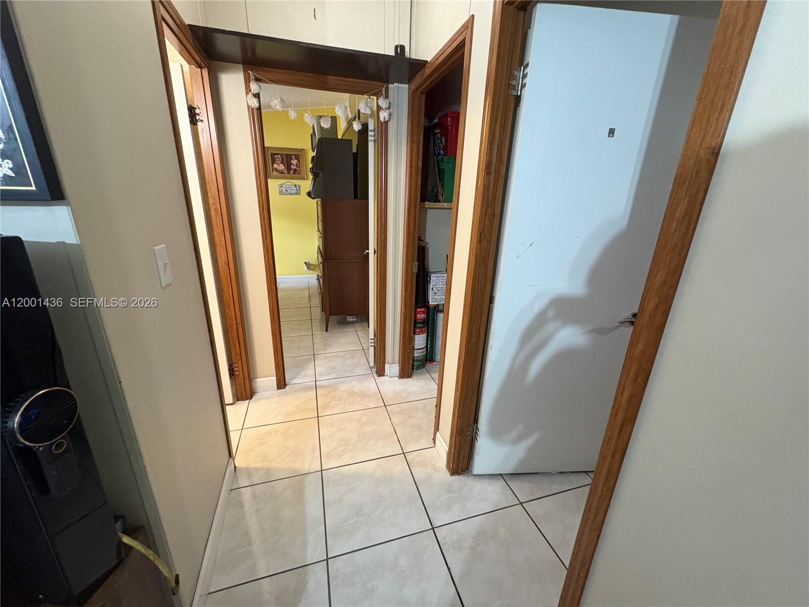 A tiled hallway features multiple doorways, a small closet, and a view into another room — 1110 SW 131 PL, Miami FL 33184, MIAMI, FL