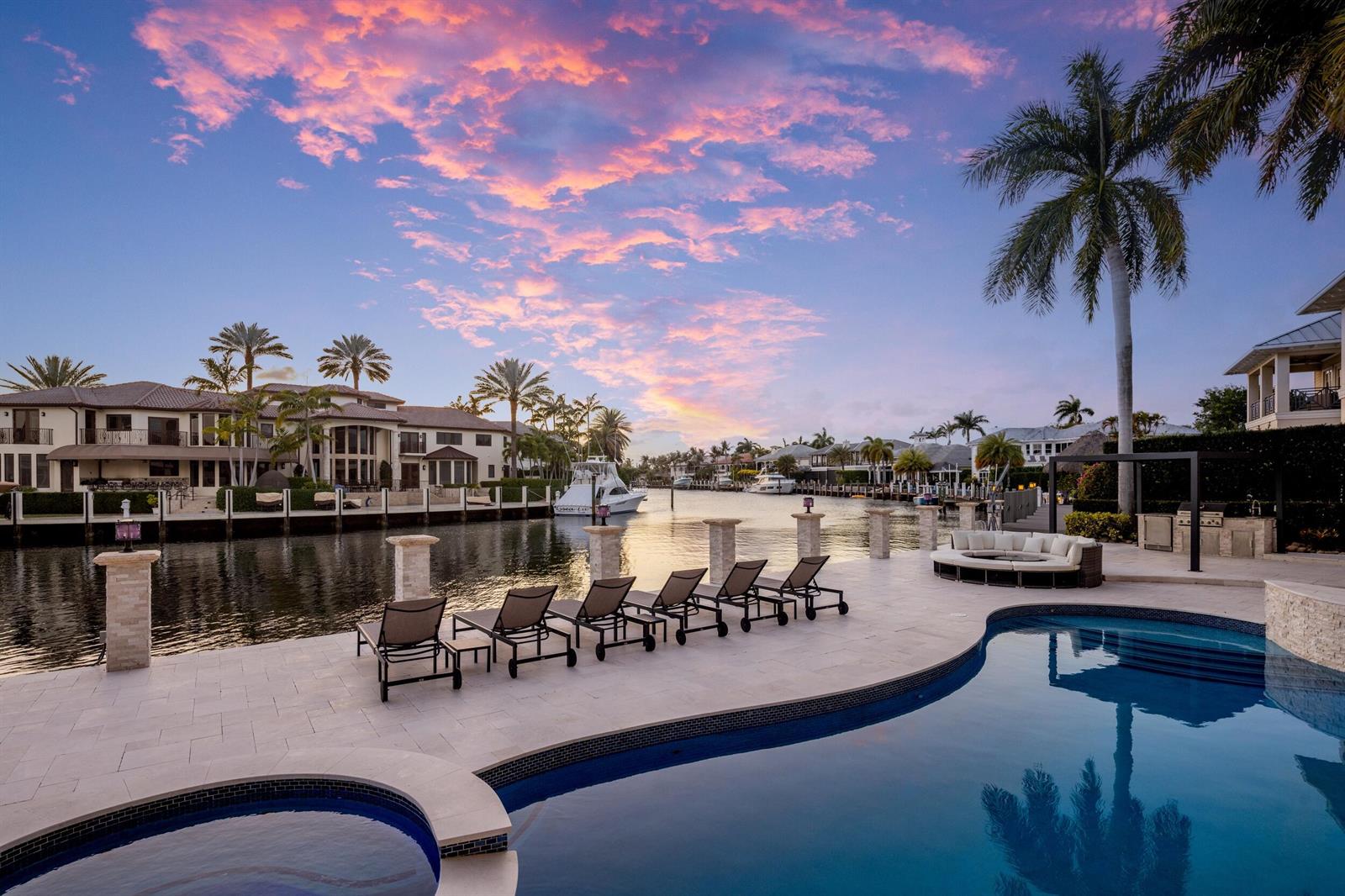 A waterfront patio features a swimming pool, lounge chairs, and a view of a canal — 3201 NE 27th Avenue, Lighthouse Point FL 33064, LIGHTHOUSE POINT, FL