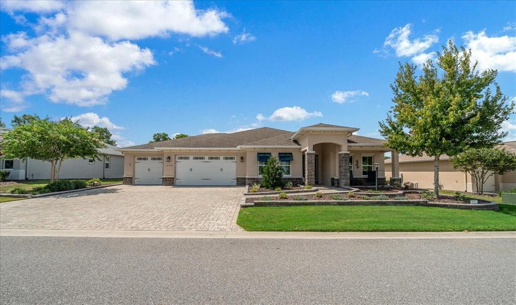 A single-story suburban house with a three-car garage and a paved driveway — 10346 SW 93RD PLACE, OCALA, FL