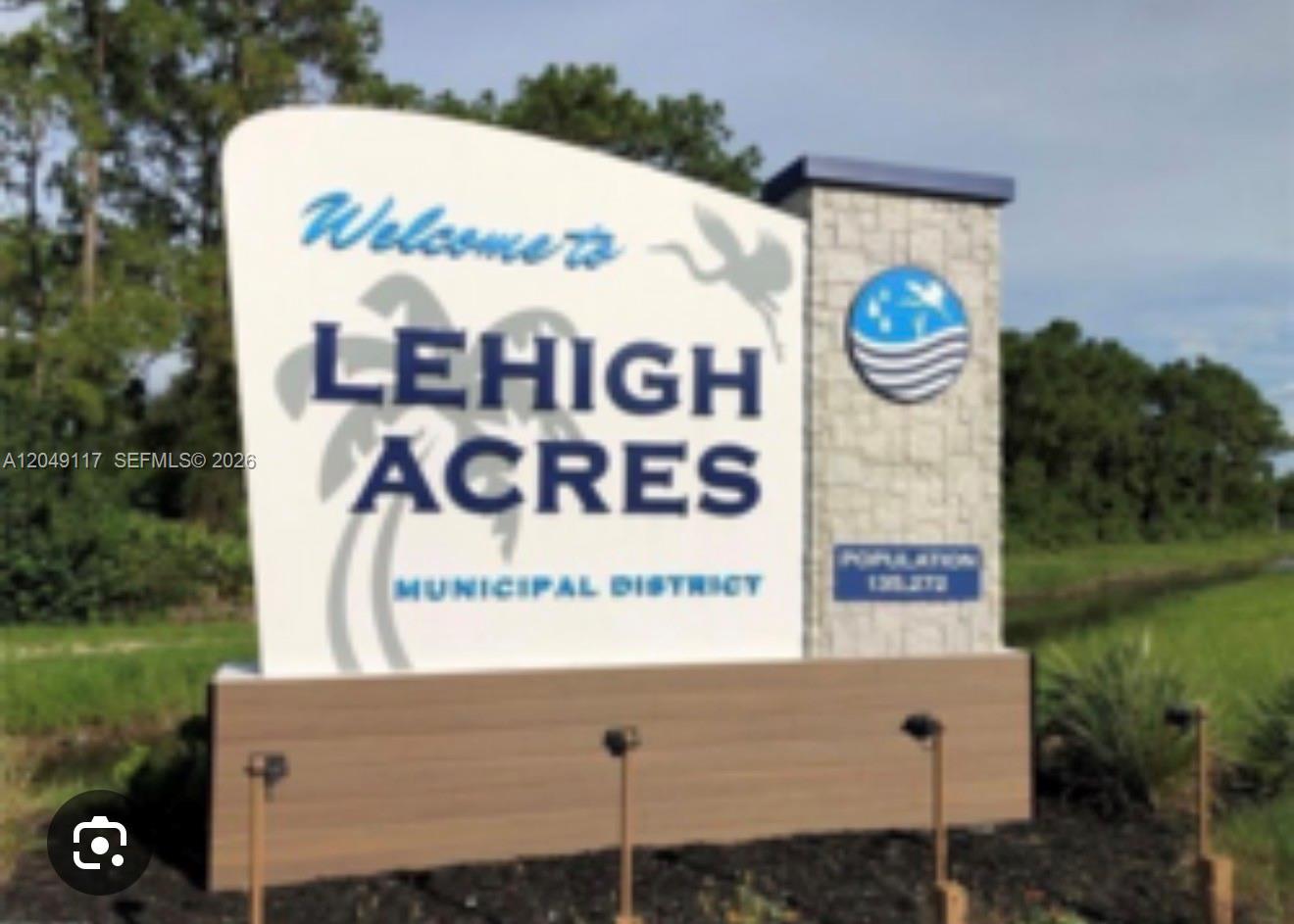 A white and stone monument sign welcomes visitors to the Lehigh Acres Municipal District — 2908 Donald Ave S, Lehigh Acres FL 33976, LEHIGH ACRES, FL