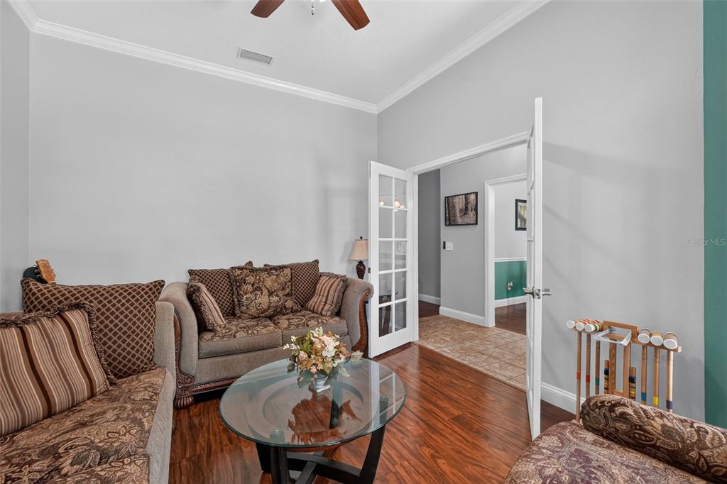 A living room features dark leather recliners, a massage chair, and a wall-mounted television — 2527 NW COUNTY ROAD 225, LAWTEY, FL