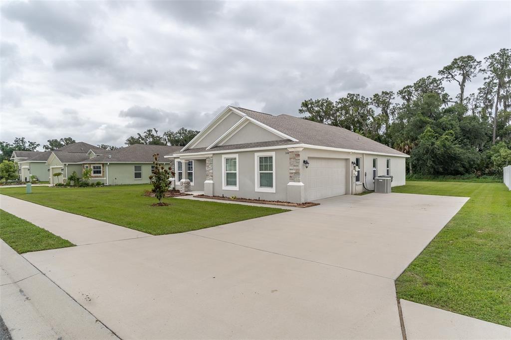 A light gray single-story house with a two-car garage and a concrete driveway — 344 KISSENGEN PARK DRIVE, BARTOW, FL
