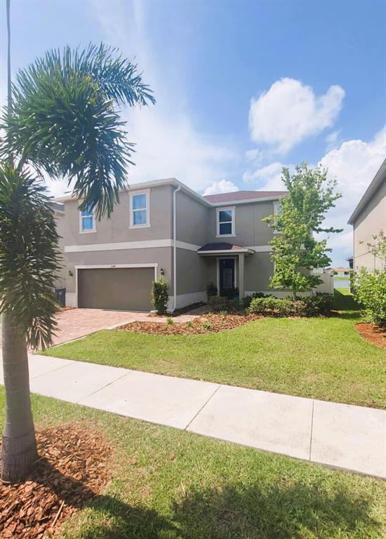 A two-story house with a tan exterior, a two-car garage, and a palm tree — 11542 BRIGHTON KNOLL LOOP, RIVERVIEW, FL