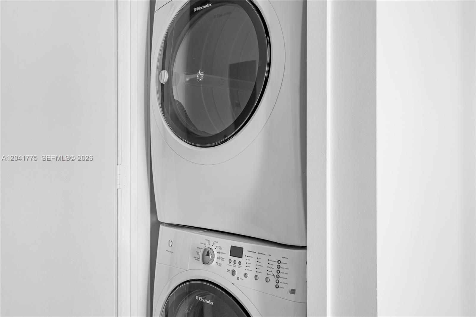 A stacked Electrolux washer and dryer unit is installed in a white laundry closet — 2900 NE 7th Ave # 1609, Miami FL 33137, MIAMI, FL