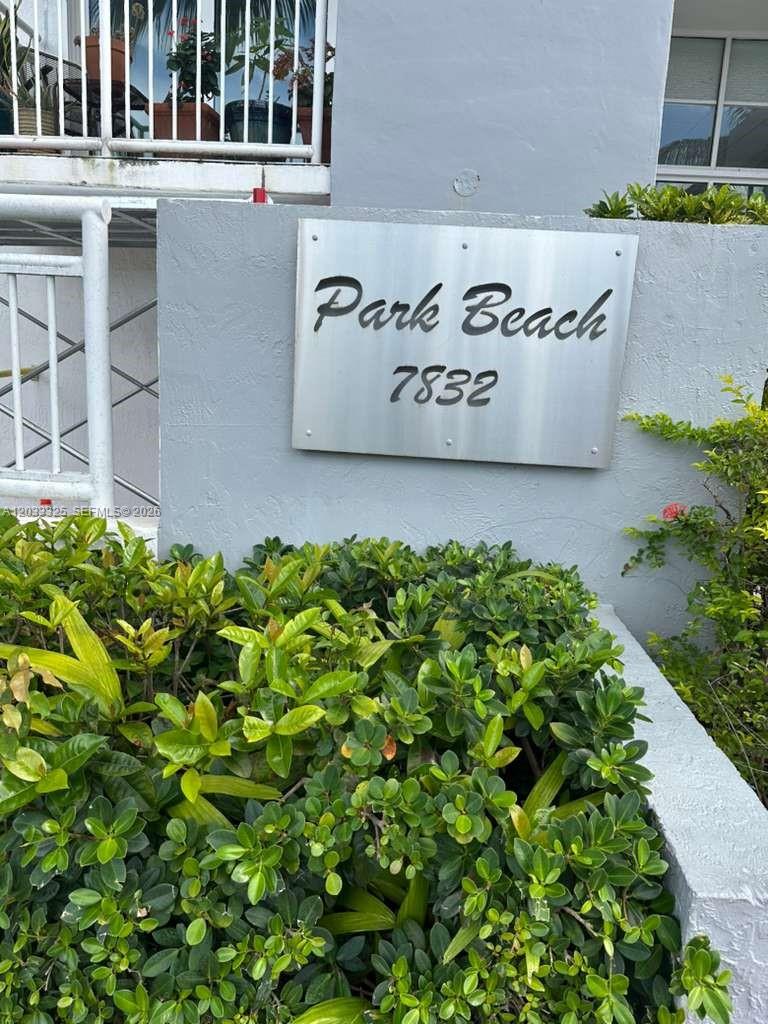 The exterior entrance of a multi-story building features a glass door and tiled walkway — 7832 Collins Ave # 406, Miami Beach FL 33141, MIAMI BEACH, FL