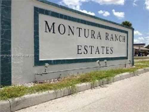 A large, light-colored sign for Montura Ranch Estates stands beside a paved road — 635 S Estribo St, Clewiston FL 33440, CLEWISTON, FL