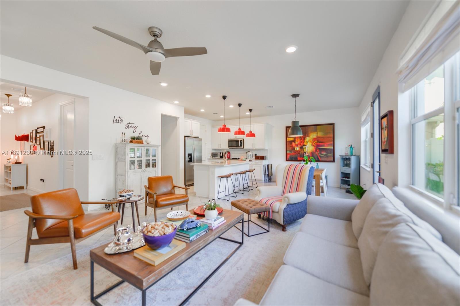 A bright open-concept living room and kitchen featuring a sofa, armchairs, and a central island — 4735 Eucalyptus Dr, Hollywood FL 33021, HOLLYWOOD, FL