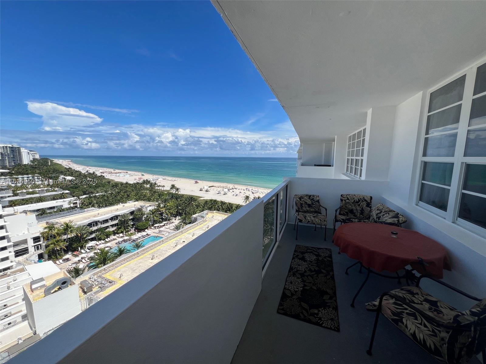 A high-rise balcony features outdoor furniture and a panoramic view of the beach and ocean — 100 Lincoln Rd # 1633, Miami Beach FL 33139, MIAMI BEACH, FL