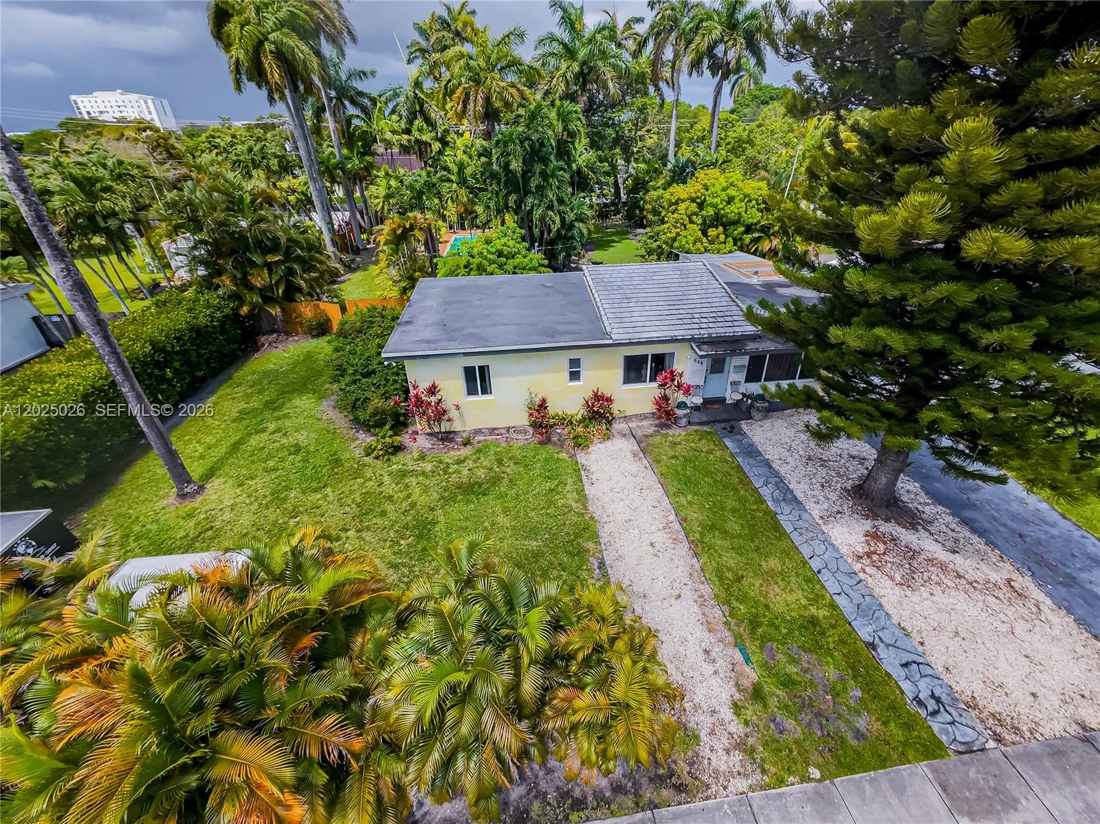 An aerial view shows a single-story yellow house with a gravel driveway and palm trees — 548 East Dr, Miami Springs FL 33166, MIAMI SPRINGS, FL