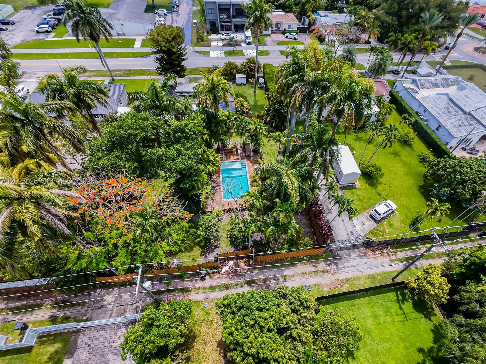 An aerial view shows a backyard with a swimming pool, palm trees, and a shed — 548 East Dr, Miami Springs FL 33166, MIAMI SPRINGS, FL