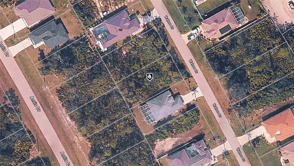 This is an aerial map view of a residential neighborhood with several houses and vacant lots — 131 WAHOO DRIVE, ROTONDA WEST, FL