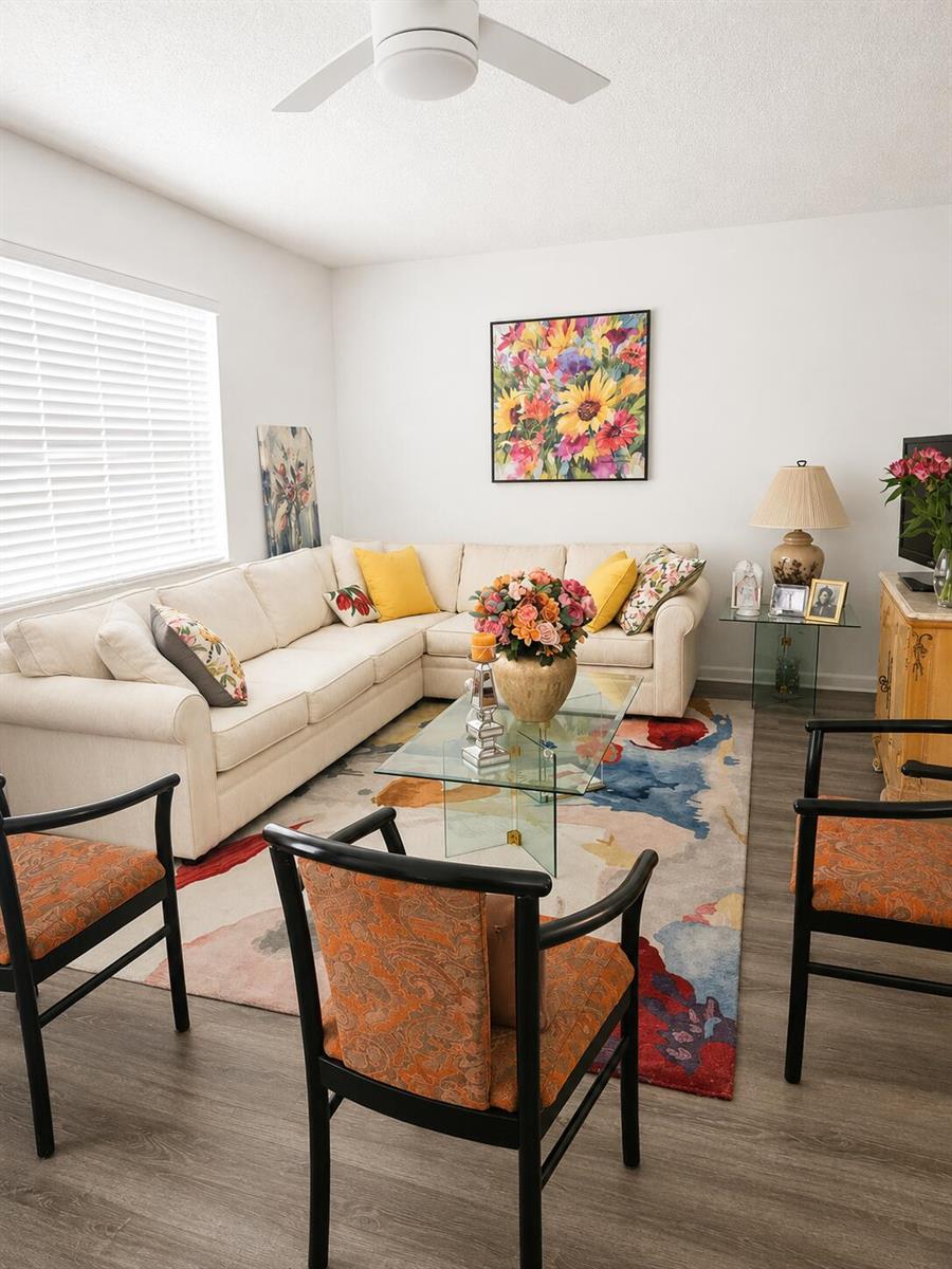 A living room features a sectional sofa, glass coffee table, and patterned area rug — 415 Normandy Lane # I, Delray Beach FL 33484, DELRAY BEACH, FL