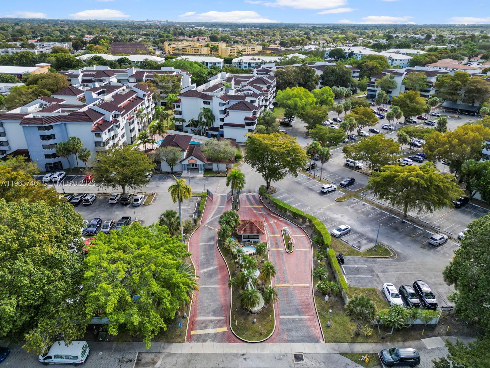 An aerial view shows a residential complex with a gated entrance, parking lots, and landscaping — 8365 SW 152nd Ave # 310, Miami FL 33193, MIAMI, FL