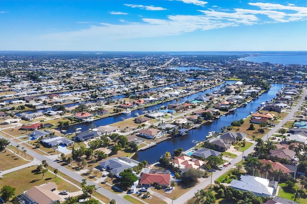 An aerial view of a residential neighborhood featuring houses along multiple man-made canals — 4358 HARBOR BOULEVARD, PORT CHARLOTTE, FL