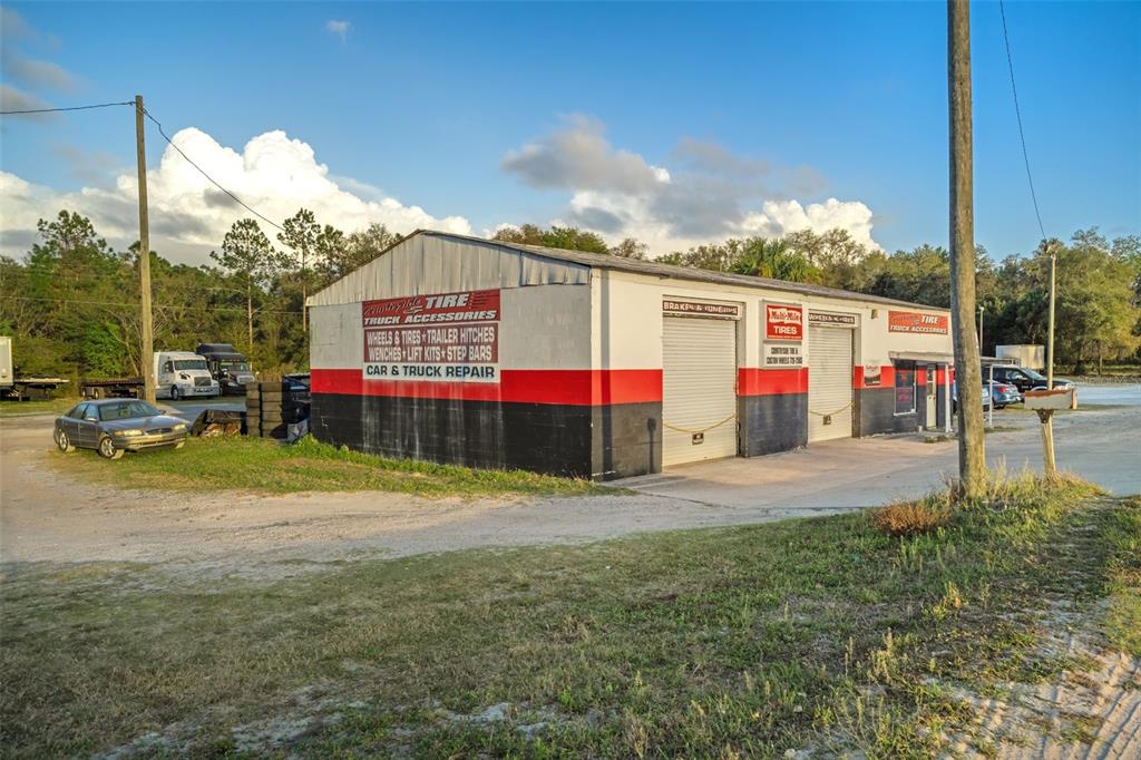 A commercial auto repair shop with a red and black exterior and multiple garage bays — 3109 S FLORIDA AVENUE, INVERNESS, FL