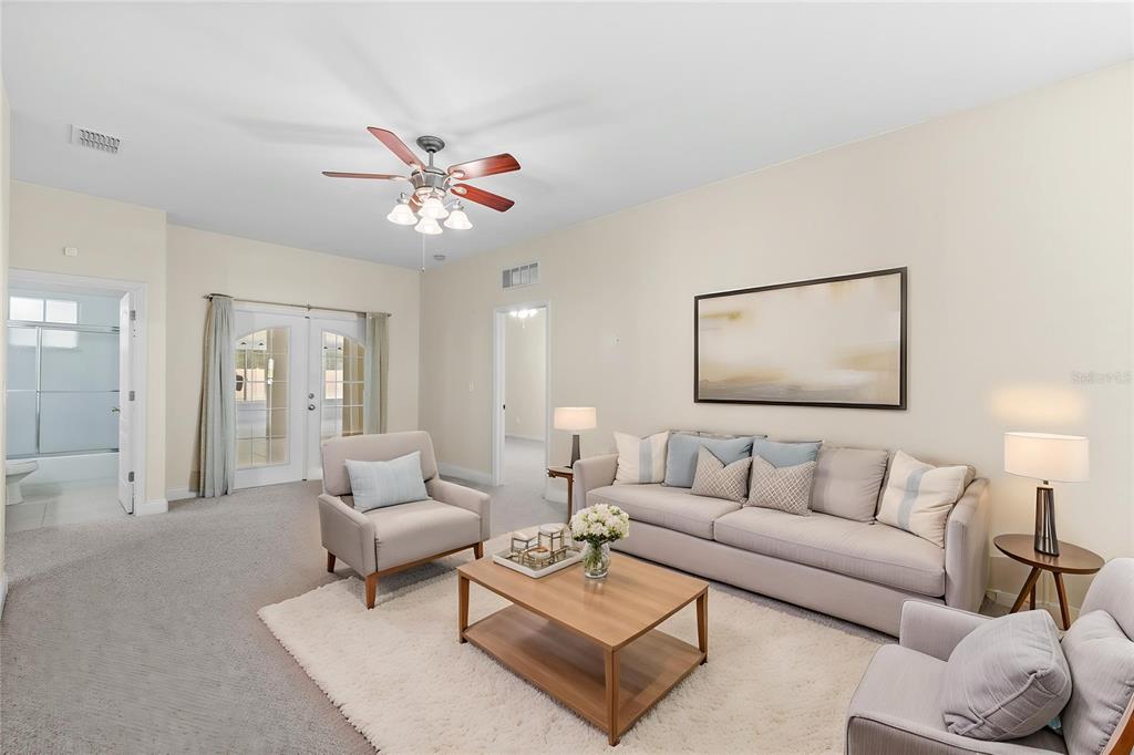 A living room features a beige sofa, two armchairs, a coffee table, and a ceiling fan — 1557 BLACKWOOD AVENUE, GOTHA, FL