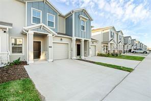 A row of modern townhomes with light-colored siding, blue accents, and concrete driveways — 3054 CHANTILLY DRIVE, DAVENPORT, FL