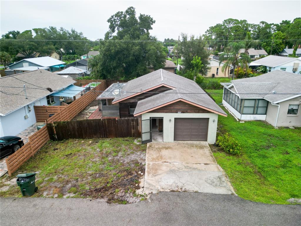 An aerial view of a single-story house with a garage, driveway, and fenced yard — 2227 BENSON STREET, SARASOTA, FL