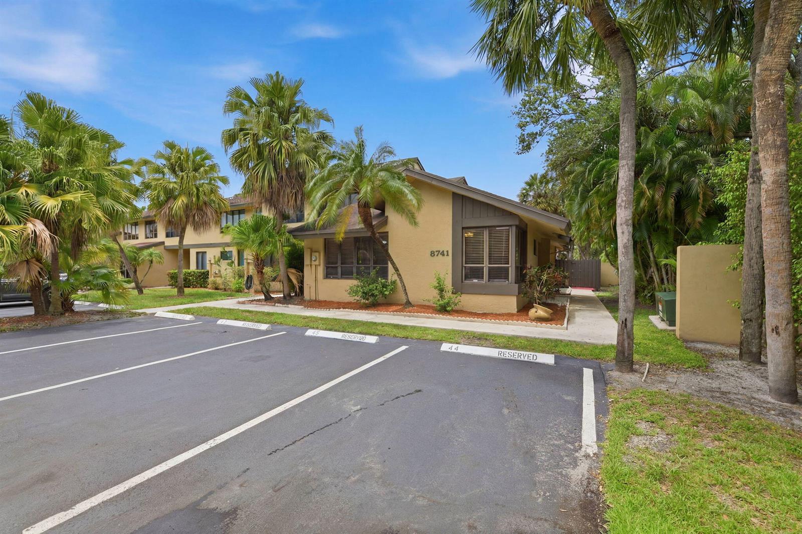 A tan building with a brown trim and reserved parking spaces in front — 8741 Cleary Boulevard, Plantation FL 33324, PLANTATION, FL