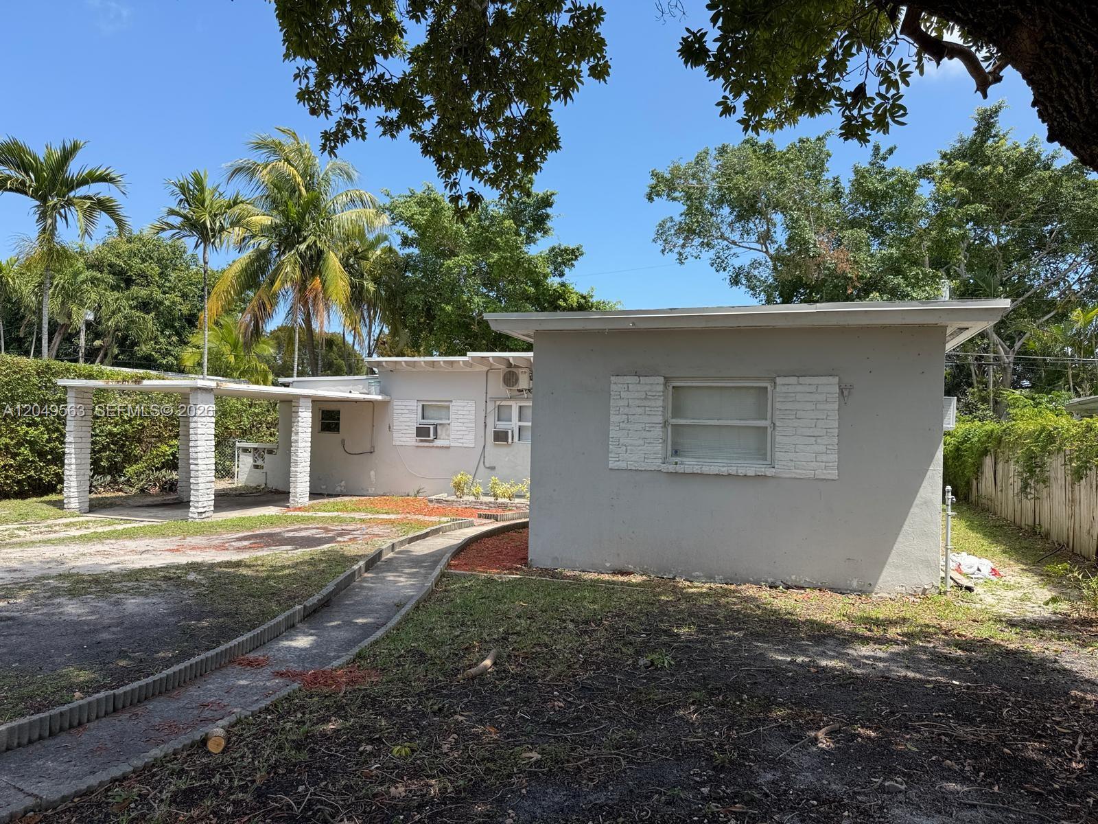 A single-story gray house with a white brick-accented window and a covered carport — 10335 NW 2nd Ct # 1, Miami FL 33150, MIAMI, FL