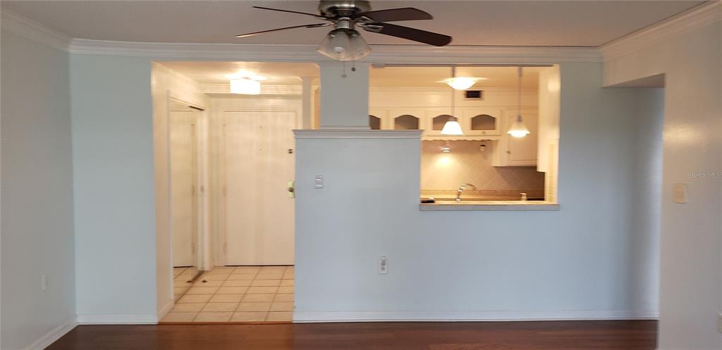 A view of a kitchen with a breakfast bar opening into a living area — 4141 BAYSHORE BOULEVARD S UNIT 1502, TAMPA, FL