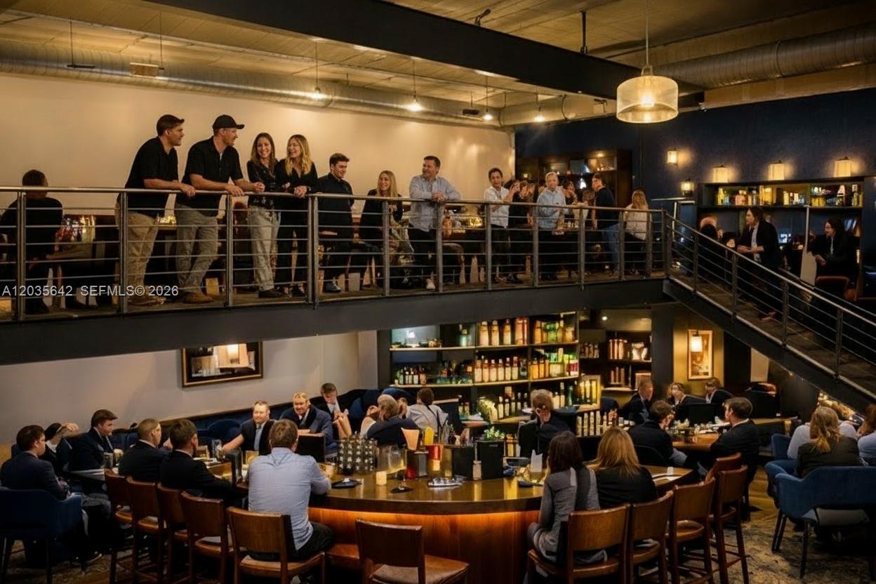 A two-story restaurant interior features a curved bar on the main floor and a balcony — First Generation Restaurant For Lease In Doral, Doral FL 33166, DORAL, FL