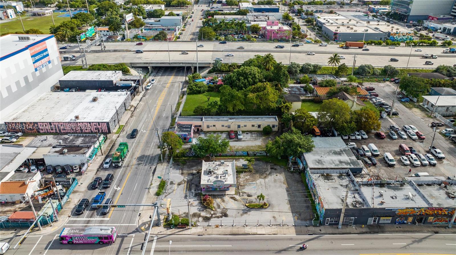 An aerial view shows a commercial property with a parking lot and surrounding urban streets — 660,662,664 NW 29th St, Miami FL 33127, MIAMI, FL