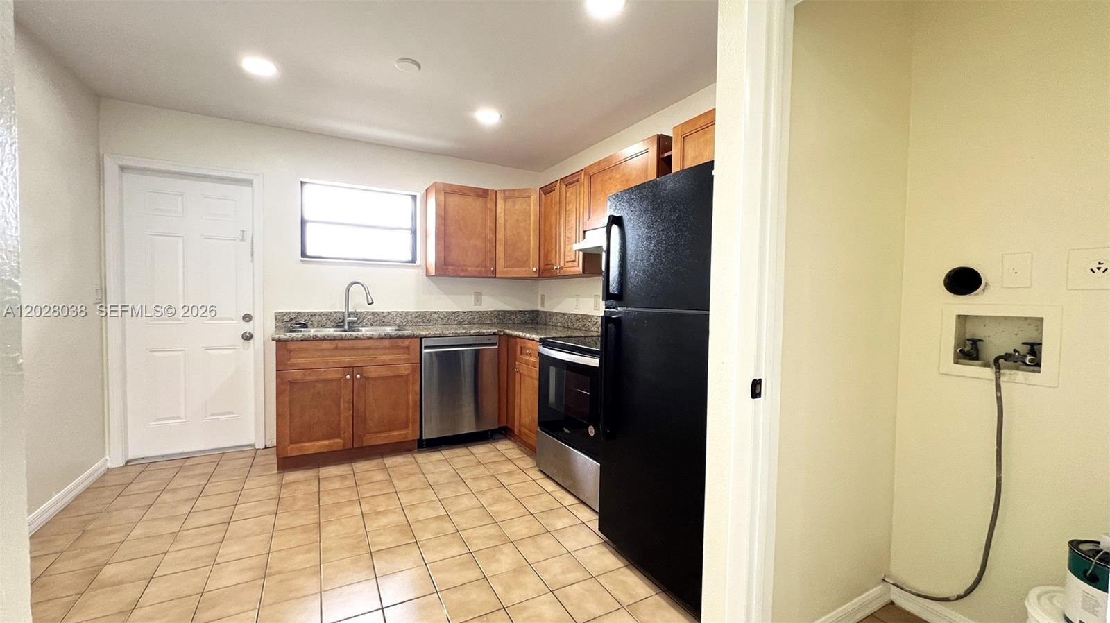 A kitchen with wood cabinets, stainless steel appliances, and a tiled floor — 5914 Taylor St # 2, Hollywood FL 33021, HOLLYWOOD, FL