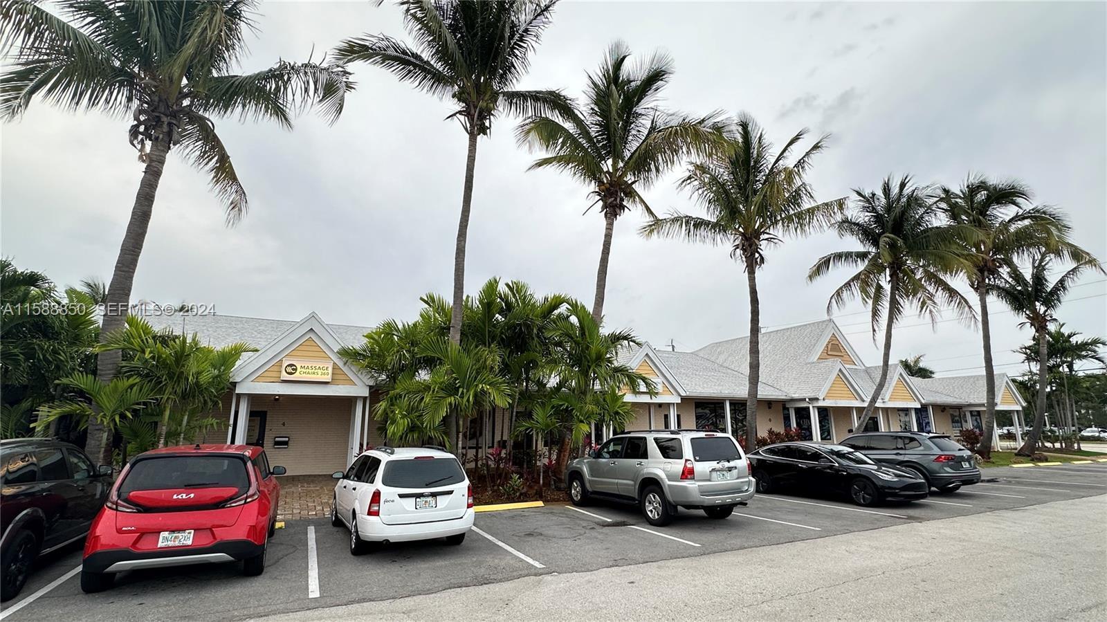 A row of commercial storefronts with yellow siding and palm trees in a parking lot — 4301 N Federal Highway # 4, Pompano Beach FL 33064, POMPANO BEACH, FL