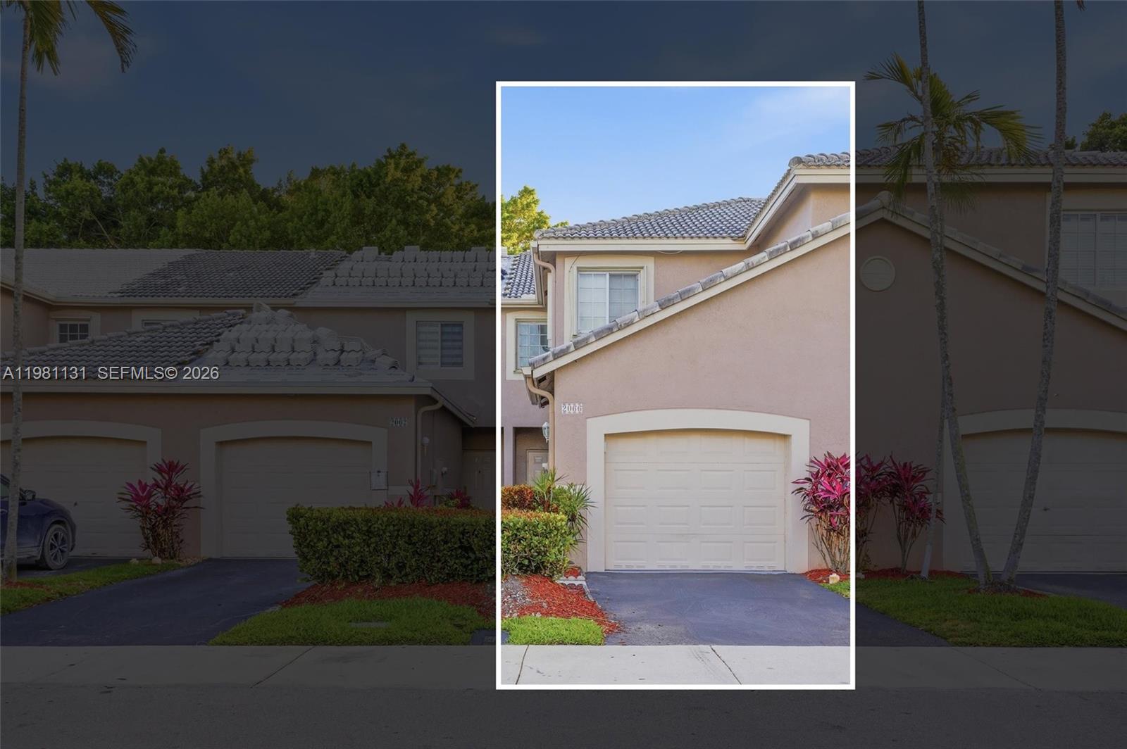 The exterior of a two-story townhouse features a beige stucco facade and a single-car garage — 2066 Madeira Dr # 2066, Weston FL 33327, WESTON, FL