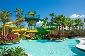 A water park with yellow and green slides leading into a swimming pool — 14501 GROVE RESORT AVENUE UNIT 3535, WINTER GARDEN, FL