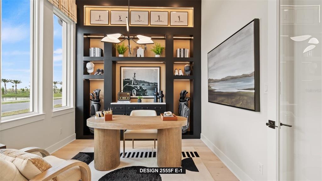 A home office features a wooden desk, built-in black shelving, and a large landscape painting — 314 HOLLY BANK AVENUE, NOKOMIS, FL