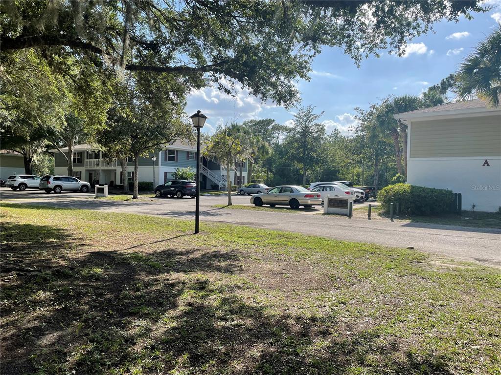 An exterior view of a multi-story apartment building with a parking lot and trees — 709 S ROOKS AVENUE, INVERNESS, FL
