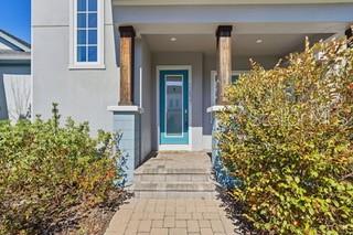 A front exterior view of a house featuring a teal door and two wooden columns — 12837 SALK WAY, ORLANDO, FL