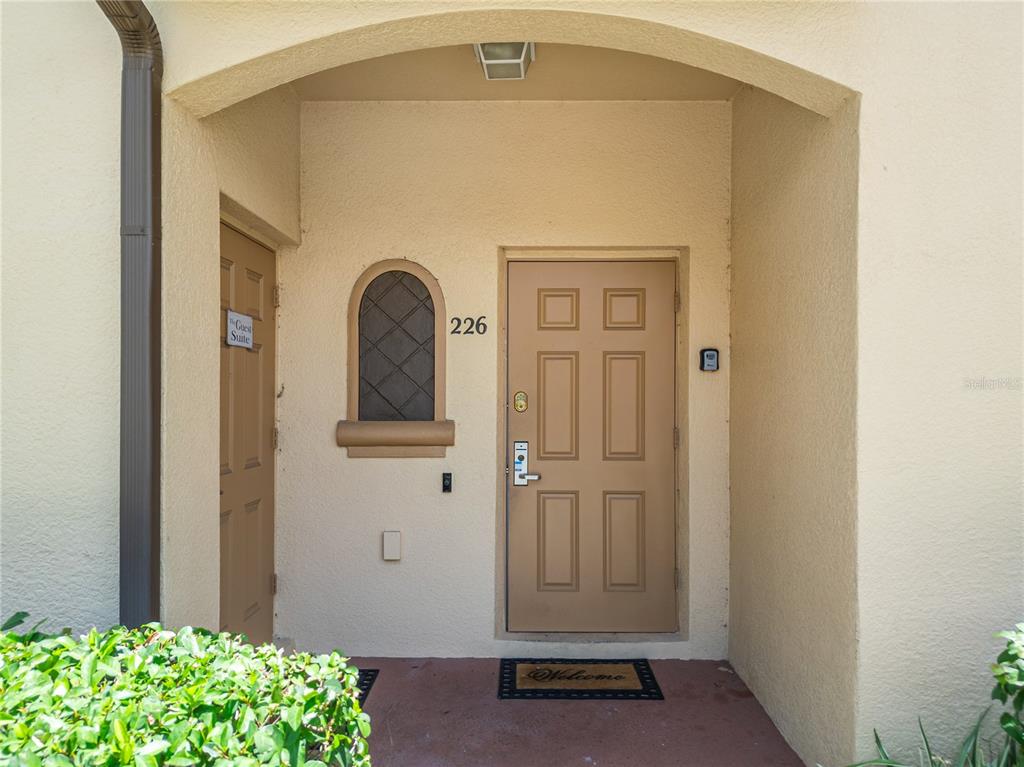 The exterior entryway features a tan door with a small window and a guest suite — 226 BERGAMO DRIVE, DAVENPORT, FL