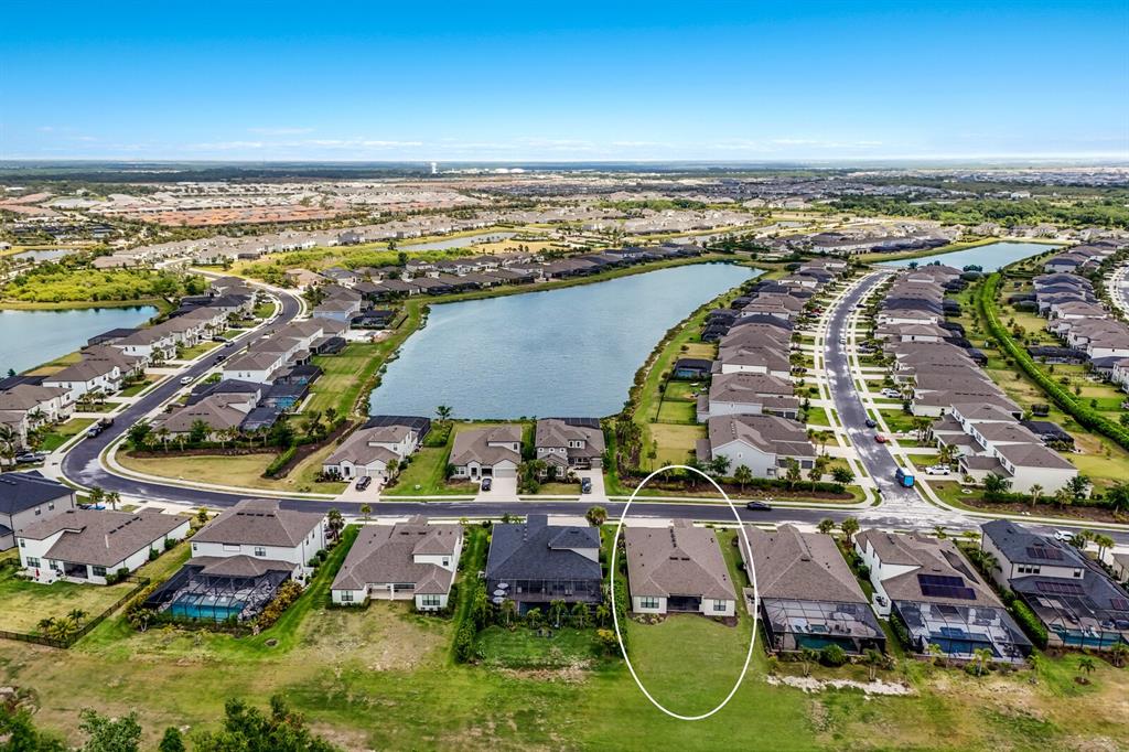 An aerial view of a suburban neighborhood highlighting a single-family home with a backyard — 4528 POND BROOK COURT, BRADENTON, FL