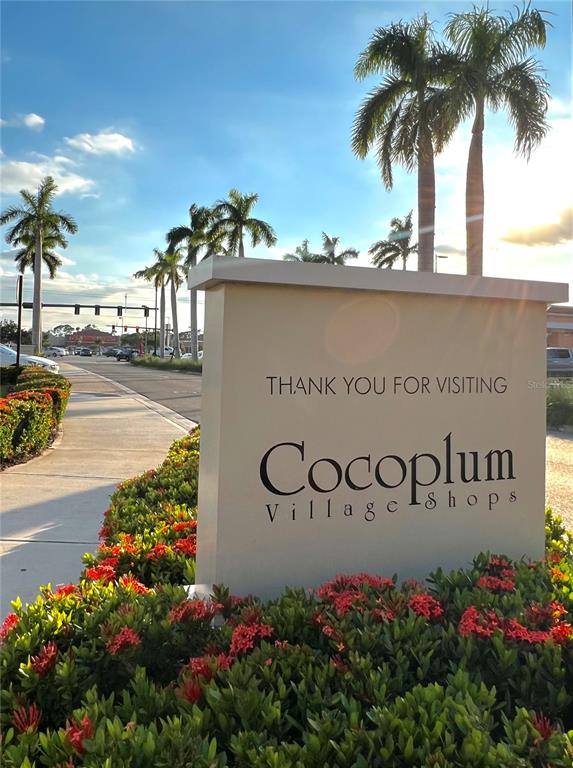 A sign for Cocoplum Village Shops stands in front of palm trees and a road — 486 DAILEY STREET, PORT CHARLOTTE, FL