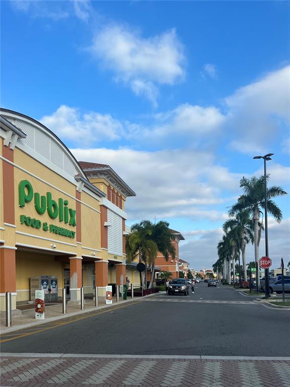 A Publix grocery store exterior with palm trees lining the parking lot under a blue sky — 486 DAILEY STREET, PORT CHARLOTTE, FL