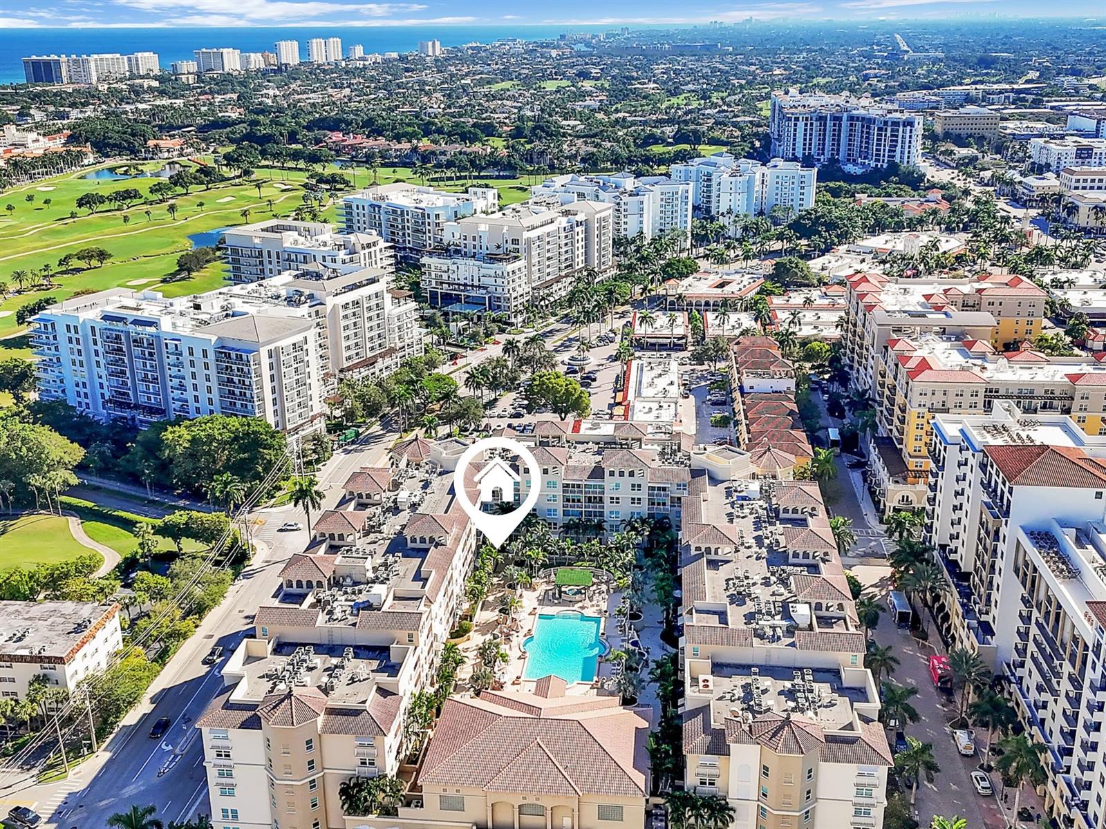 Aerial view of a multi-story residential complex with a central swimming pool and courtyard — 99 SE Mizner Boulevard # 612, Boca Raton FL 33432, BOCA RATON, FL