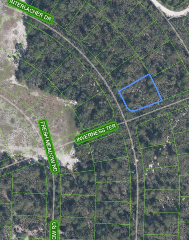 This is an aerial map showing a vacant, wooded lot highlighted in blue near a road intersection — 10581 INTERLACHER DRIVE, SEBRING, FL
