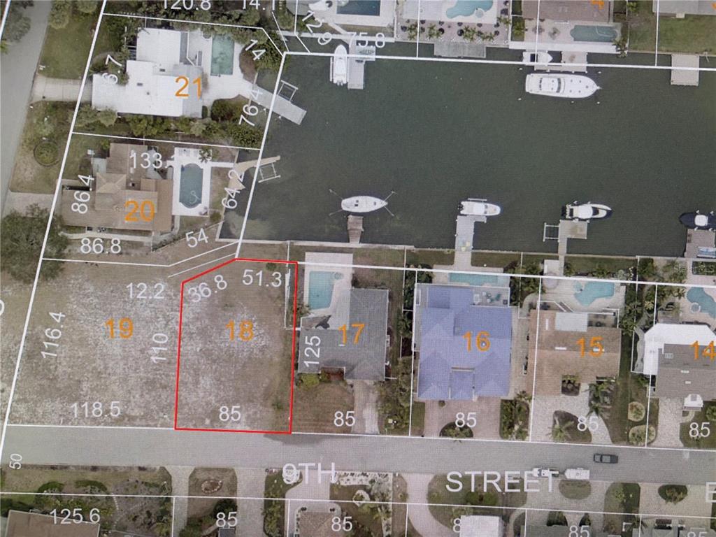This is an aerial map showing a vacant waterfront lot highlighted in red — 9 TH STREET E, TIERRA VERDE, FL