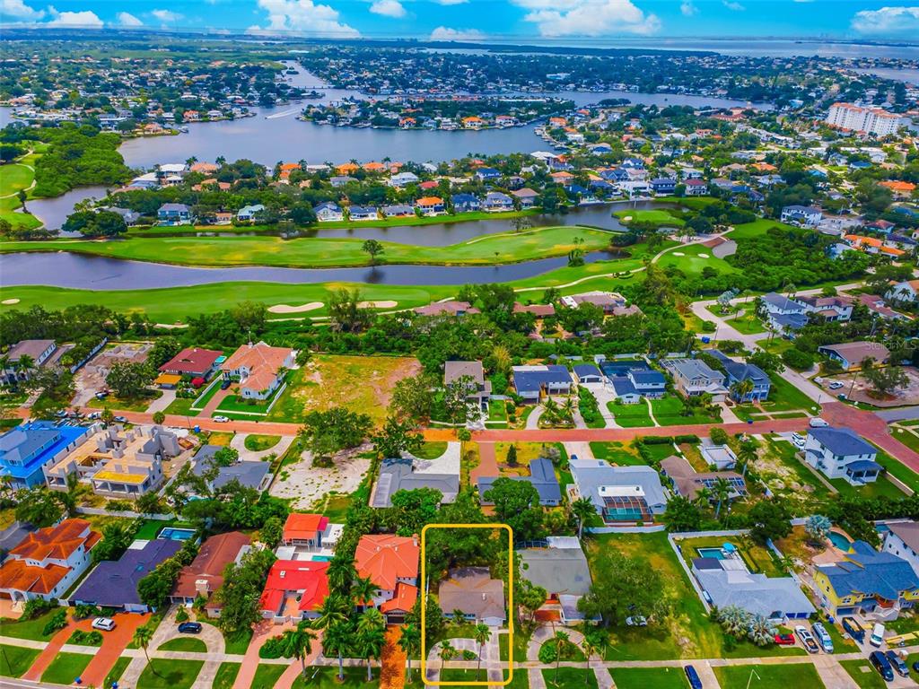 An aerial view shows a residential neighborhood with a highlighted house near a golf course — 910 SNELL ISLE BOULEVARD NE, ST PETERSBURG, FL