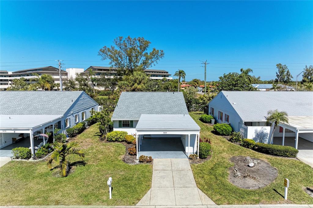 An exterior view of a single-story house with a carport and a concrete driveway — 9417 KINGSTON DRIVE UNIT 9417, BRADENTON, FL