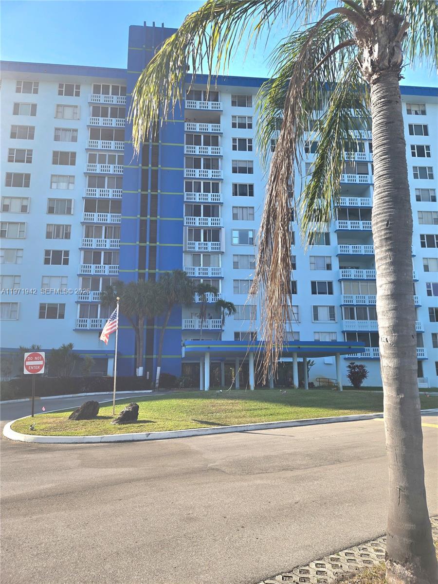 A multi-story blue apartment building with a palm tree in the foreground — 4001 Hillcrest Dr # 909, Hollywood FL 33021, HOLLYWOOD, FL