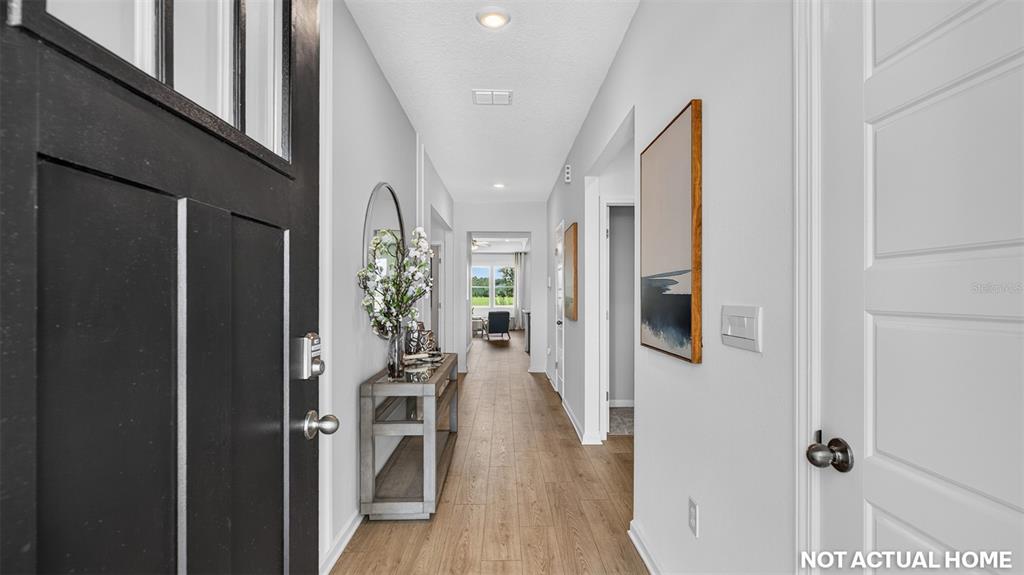 This is a rendering of a home entryway with a hallway leading to a living area — 155 SPRINGWOOD DRIVE, PALM COAST, FL