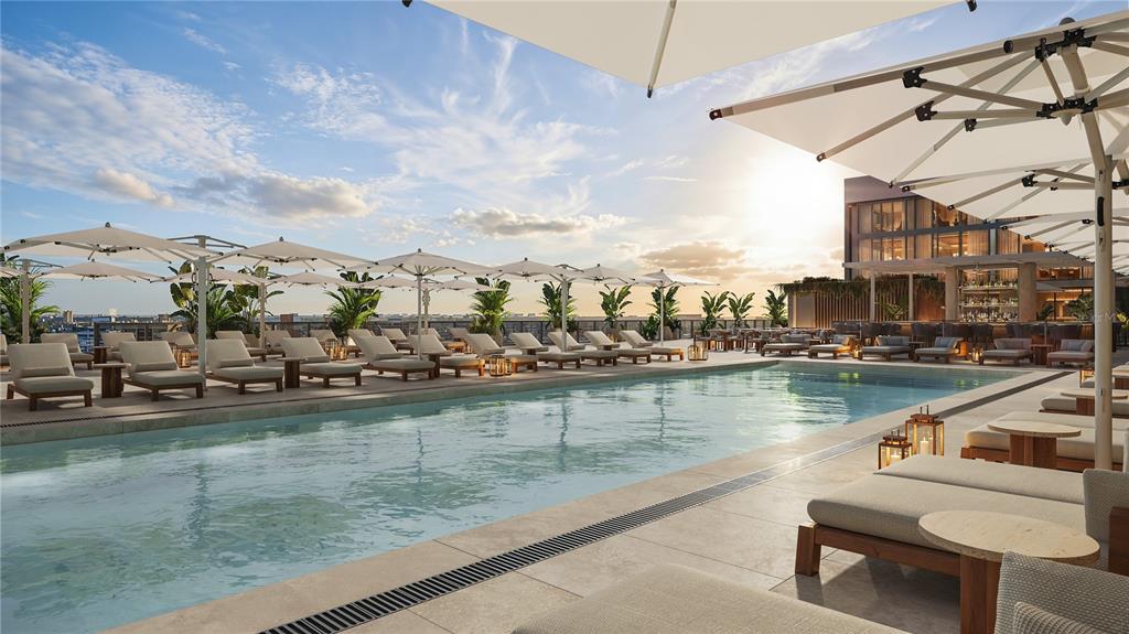This rendering shows a rooftop swimming pool surrounded by lounge chairs and umbrellas at sunset — 111 S ASHLEY DRIVE UNIT 2107, TAMPA, FL