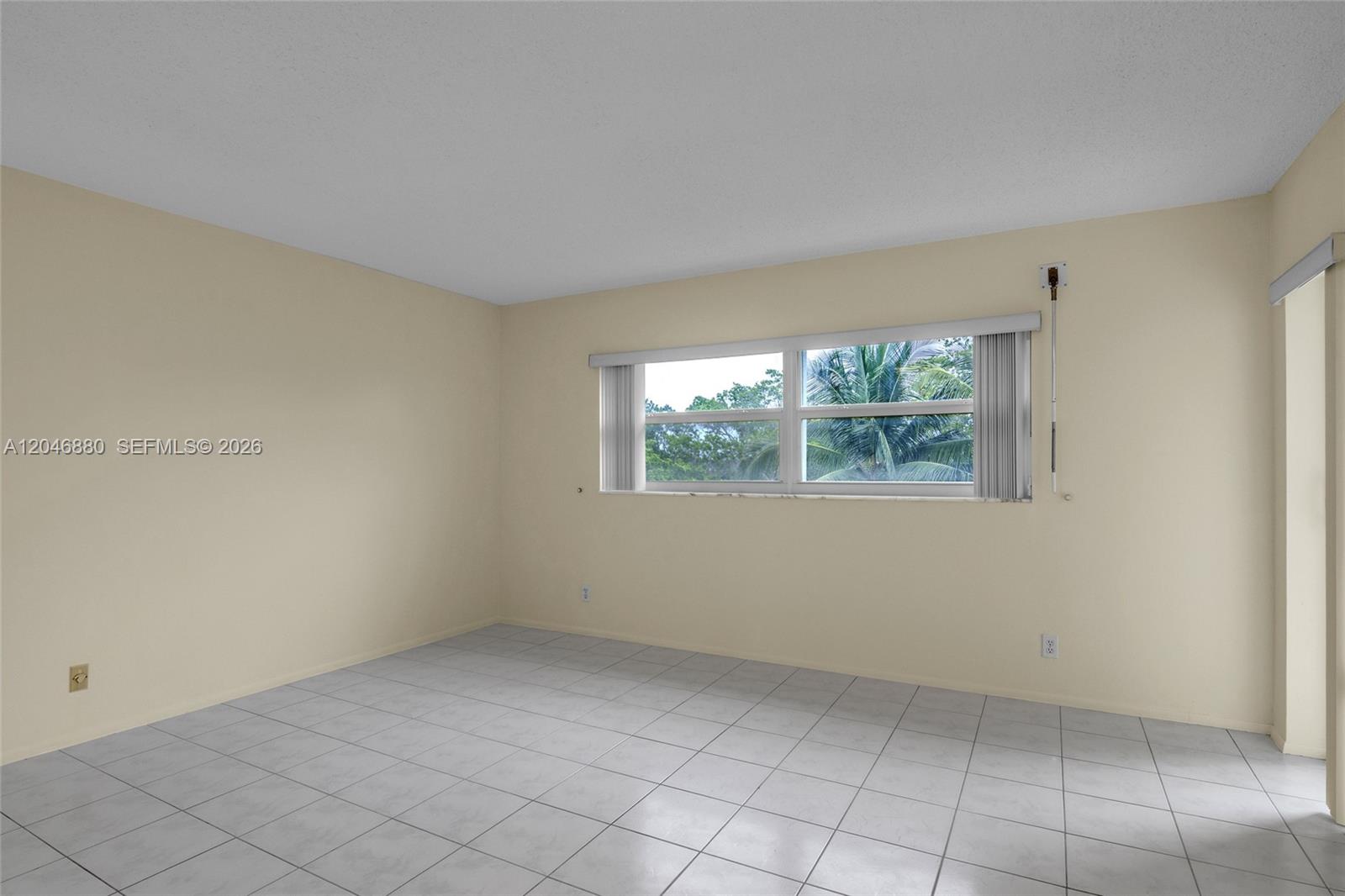 An empty room features light-colored walls, white tile flooring, and a window with blinds — 1000 NE 14th Ave # 503, Hallandale Beach FL 33009, HALLANDALE BEACH, FL