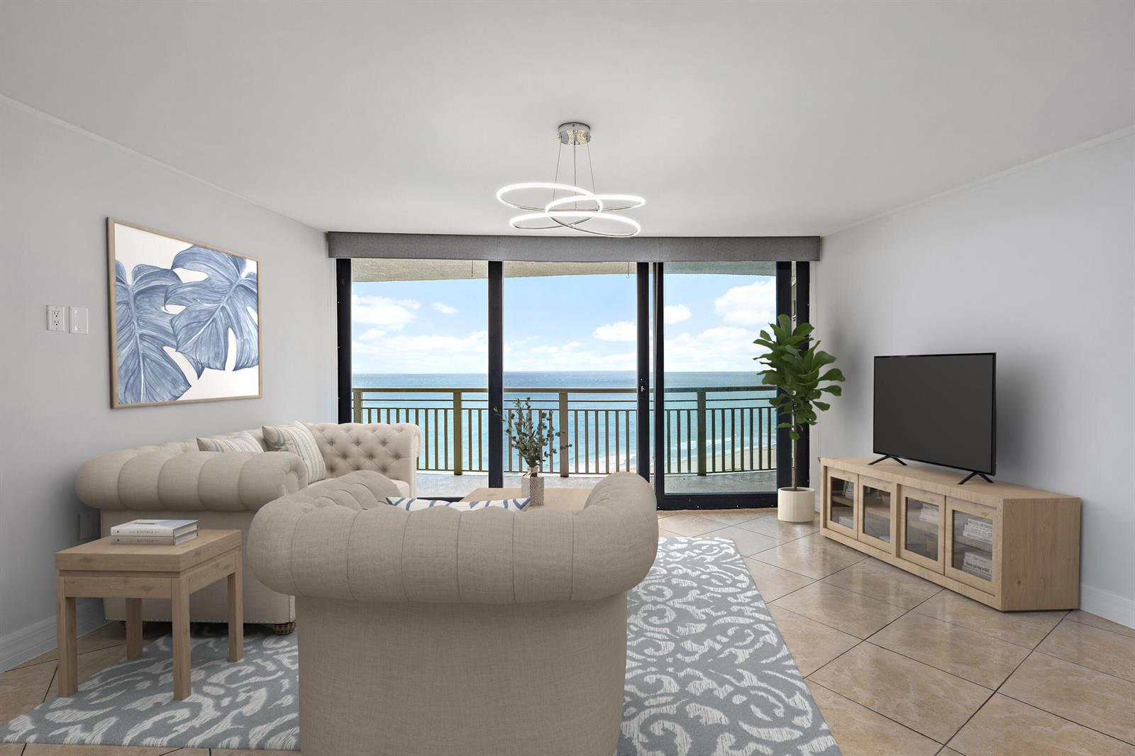 This living room features a tufted sofa, a television console, and a balcony overlooking the ocean — 3000 N Ocean Drive # 17d, Riviera Beach FL 33404, RIVIERA BEACH, FL