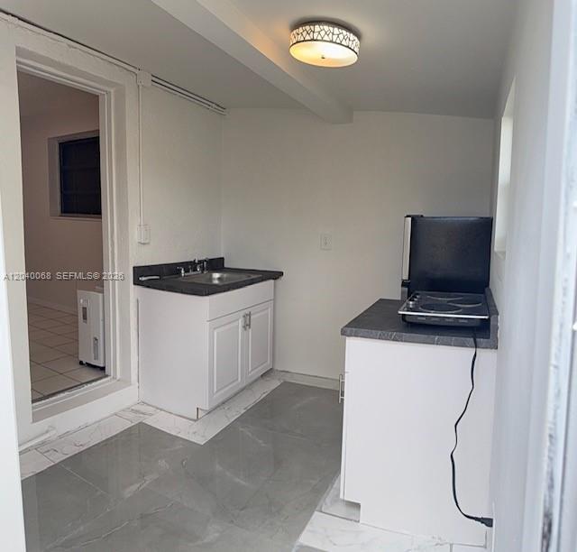 A small kitchen area features white cabinets, a sink, and a portable electric cooktop — 5641 SW 39th St, West Park FL 33023, WEST PARK, FL